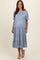 woman wearing a light blue maternity tiered midi dress with short puff sleeves and a baby bump visible