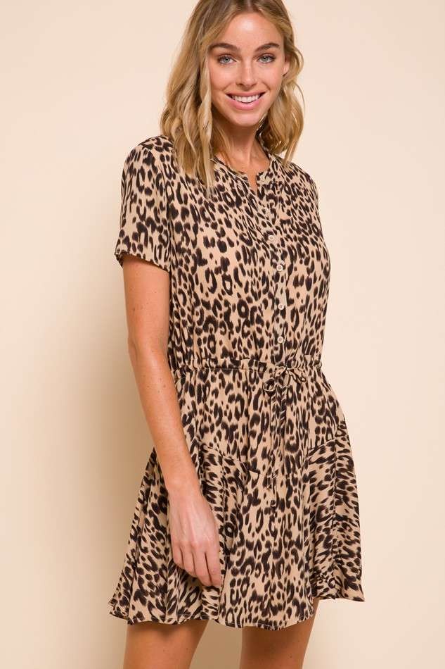 woman wearing a short sleeve leopard print dress with a button front and cinched waist