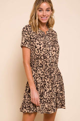 woman wearing a short sleeve leopard print dress with a button front and cinched waist