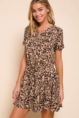 woman wearing a short sleeve leopard print dress with a tie waist detail