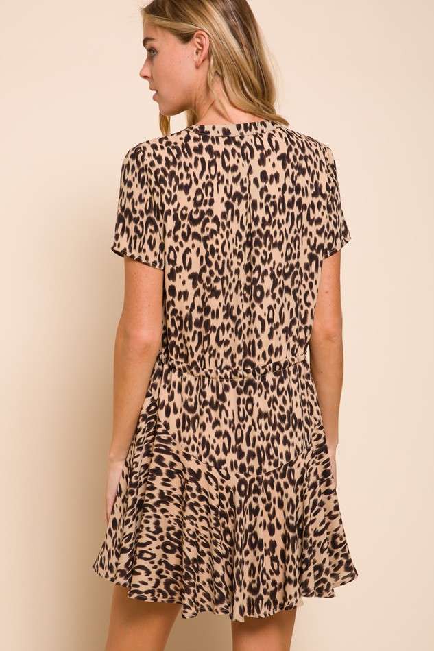 woman wearing a short-sleeve beige leopard print dress with a flared skirt and a relaxed fit