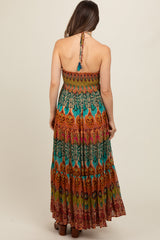woman wearing a colorful printed strapless maternity maxi dress with a back tie detail