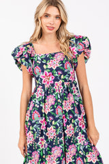 woman wearing a navy blue floral print maxi dress with puff sleeves and a square neckline