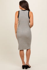 woman wearing a black and white striped maternity dress, showing a fitted style and knee-length cut from the back