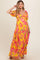 woman wearing a yellow floral maxi dress with puff sleeves and a baby bump visible