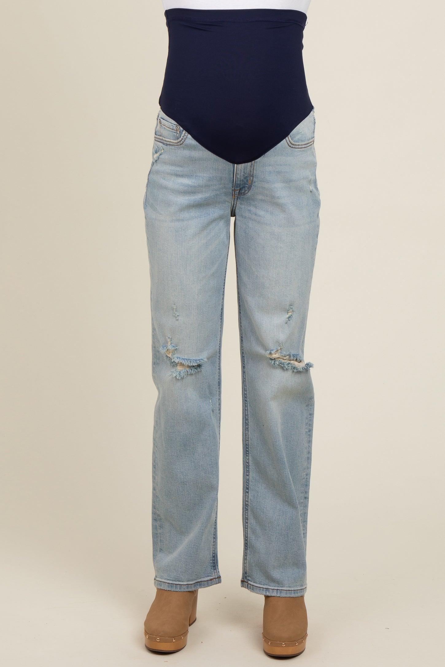 maternity wear light blue distressed jeans with a navy blue belly support panel worn by a model