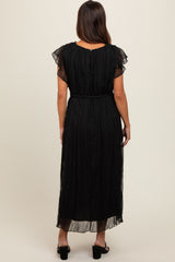 woman wearing a black maternity maxi dress with flutter sleeves and a belted waist, showing flowing fabric from the back