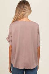 woman wearing a mauve short sleeve maternity top, featuring a relaxed fit and round hem with a smooth back design