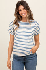 woman wearing a striped maternity top with puff sleeves and a visible baby bump, paired with jeans