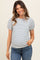 woman wearing a striped maternity top with puff sleeves and a visible baby bump, paired with jeans