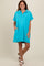 woman wearing an aqua blue short sleeve polo dress with a relaxed fit and side pockets