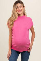 woman wearing a hot pink short sleeve maternity top and showing her baby bump