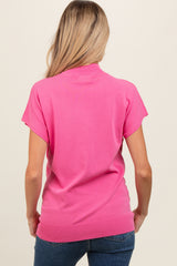 woman wearing a pink short sleeve maternity top, view from the back, styled with blue jeans
