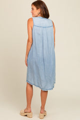 woman wearing a light wash sleeveless denim dress with a back pleat and frayed hem, styled with espadrille sandals