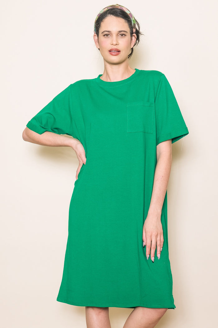 woman wearing a vibrant green short sleeve t-shirt dress with a front pocket