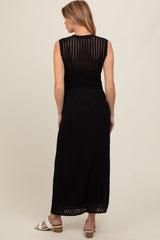 woman wearing a black sleeveless maternity maxi dress with vertical stripes, showing her back