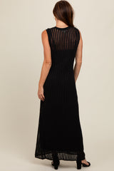 woman wearing a long black sleeveless maxi dress with ribbed texture and an open back view
