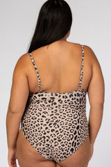 Back view of a woman wearing a leopard print one-piece swimsuit with adjustable spaghetti straps