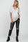 pregnant woman wearing a grey v-neck maternity t-shirt and black distressed jeans with ankle boots