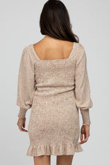 woman wearing a beige floral print mini dress with puff sleeves and a ruffled hem viewed from the back