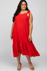 woman wearing a red plus-size maxi dress with a ruffled hem and tie shoulder details