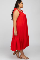 woman wearing a red plus size sleeveless dress with bow details and a ruffled hemline