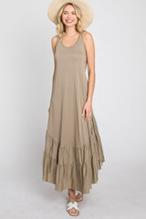 woman wearing a taupe sleeveless tiered maxi dress and straw sun hat against a white background