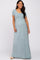 smiling pregnant woman wearing a light blue short sleeve maternity maxi dress against a white background