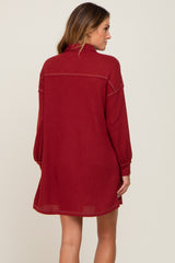 Back view of a woman wearing a burgundy long sleeve waffle knit shirt dress