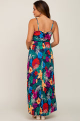 woman wearing a colorful floral maternity maxi dress with adjustable spaghetti straps, showing the back view