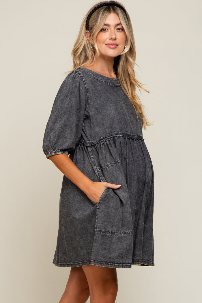 pregnant woman wearing a charcoal grey acid wash denim maternity dress with puff sleeves and pockets