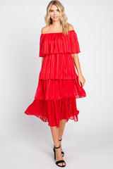 woman wearing a red off-the-shoulder tiered dress with ruffles and a flowy silhouette