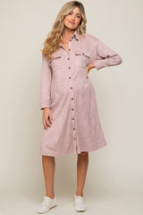 woman wearing a mauve corduroy button down maternity shirt dress and white sneakers
