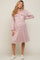 woman wearing a mauve corduroy button down maternity shirt dress and white sneakers