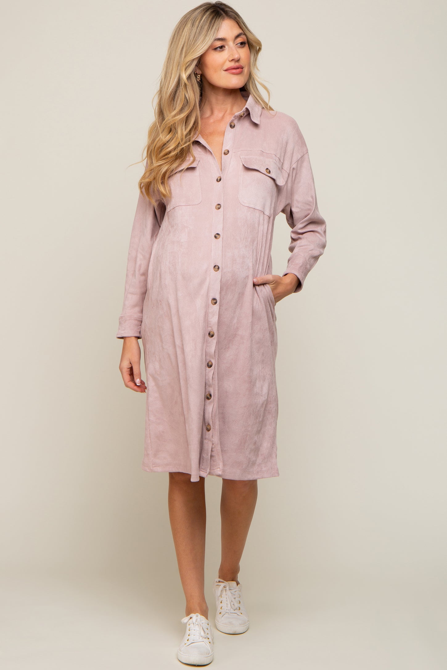 Woman wearing a mauve corduroy maternity shirt dress with buttons and pockets