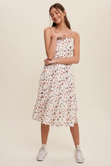 woman wearing a white floral midi dress with spaghetti straps and white high-top sneakers