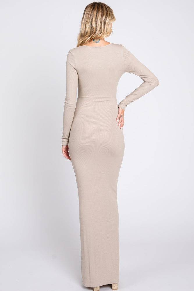 woman wearing a fitted beige long sleeve maxi dress from the back