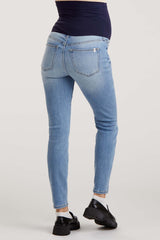 maternity wear light blue skinny jeans with a stretchy waistband, model showing a baby bump from the back