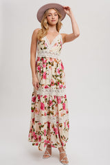woman wearing a floral maxi dress with lace details and a wide-brimmed hat